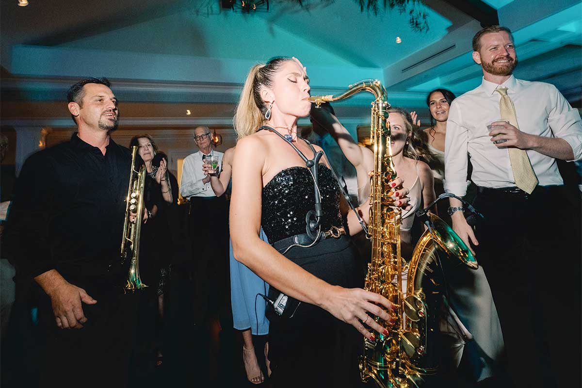 The Brett Foreman Band saxophonist playing for a crowded dance floor