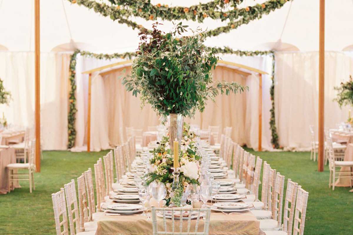 Wedding reception tent with custom drapery, florals and table settings by Foreman Productions
