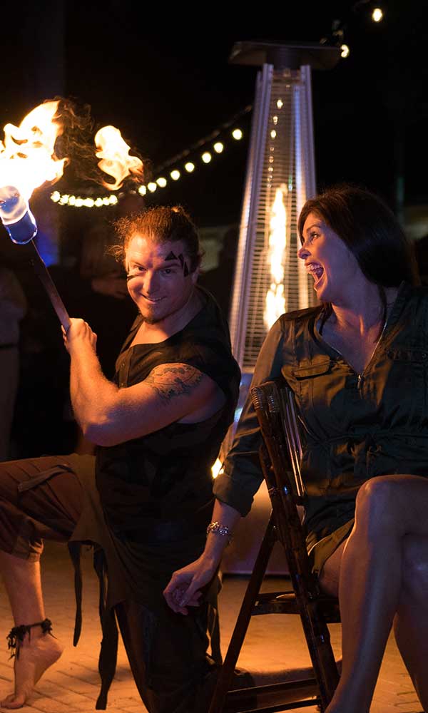 Fire dancer with thrilled guest at a fundraising event in Naples, Florida